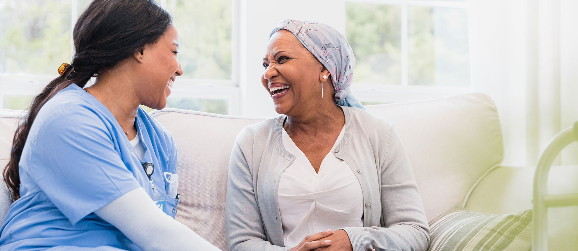 Nurse talking and laughing with a Cancer Patient